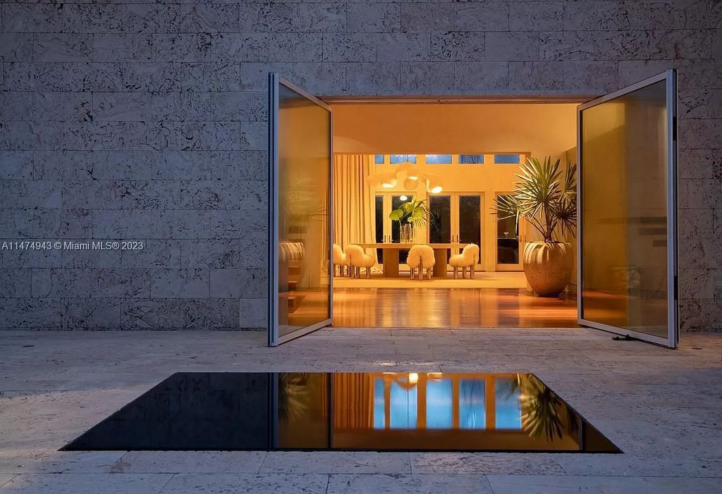 Villa Allegra, a masterpiece by architect Chad Oppenheim, epitomizes waterfront luxury on Sunset Island III. This stunning estate seamlessly blends classical elegance with contemporary allure across its 6,011 square feet of living space, featuring six bedrooms and seven baths on a 0.32-acre lot.