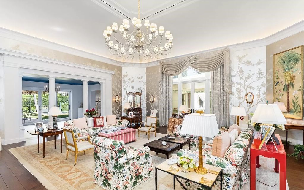 Nestled in Palm Beach's prestigious Estate Section, this 1.3+/- acre property epitomizes luxury living with a stunning clay tennis court, two guest houses, and immaculate grounds. A gated entry leads to a circular drive and ample parking, complemented by a separate service area and a 2-car garage.