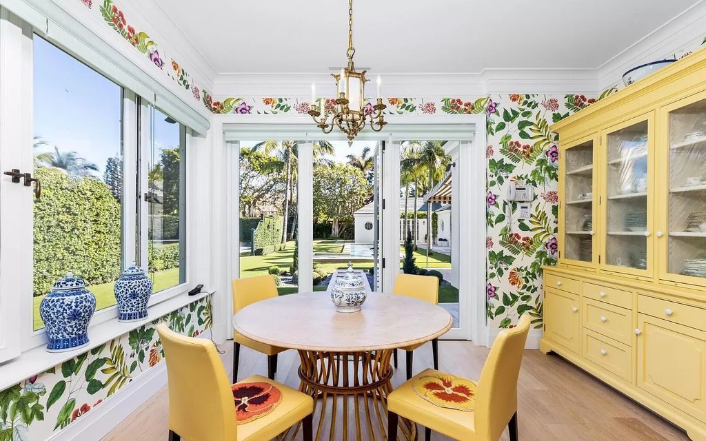 Nestled in Palm Beach's prestigious Estate Section, this 1.3+/- acre property epitomizes luxury living with a stunning clay tennis court, two guest houses, and immaculate grounds. A gated entry leads to a circular drive and ample parking, complemented by a separate service area and a 2-car garage.