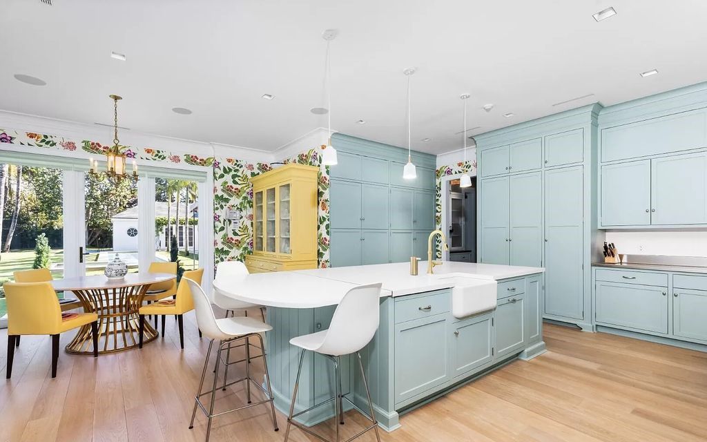 Nestled in Palm Beach's prestigious Estate Section, this 1.3+/- acre property epitomizes luxury living with a stunning clay tennis court, two guest houses, and immaculate grounds. A gated entry leads to a circular drive and ample parking, complemented by a separate service area and a 2-car garage.
