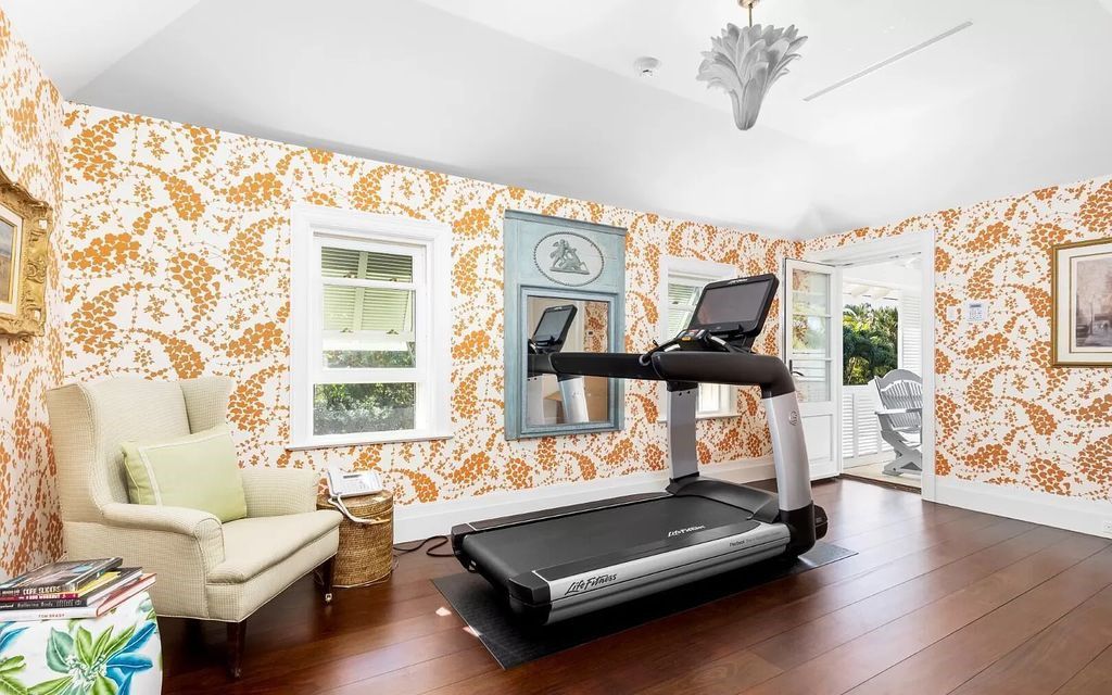 Nestled in Palm Beach's prestigious Estate Section, this 1.3+/- acre property epitomizes luxury living with a stunning clay tennis court, two guest houses, and immaculate grounds. A gated entry leads to a circular drive and ample parking, complemented by a separate service area and a 2-car garage.