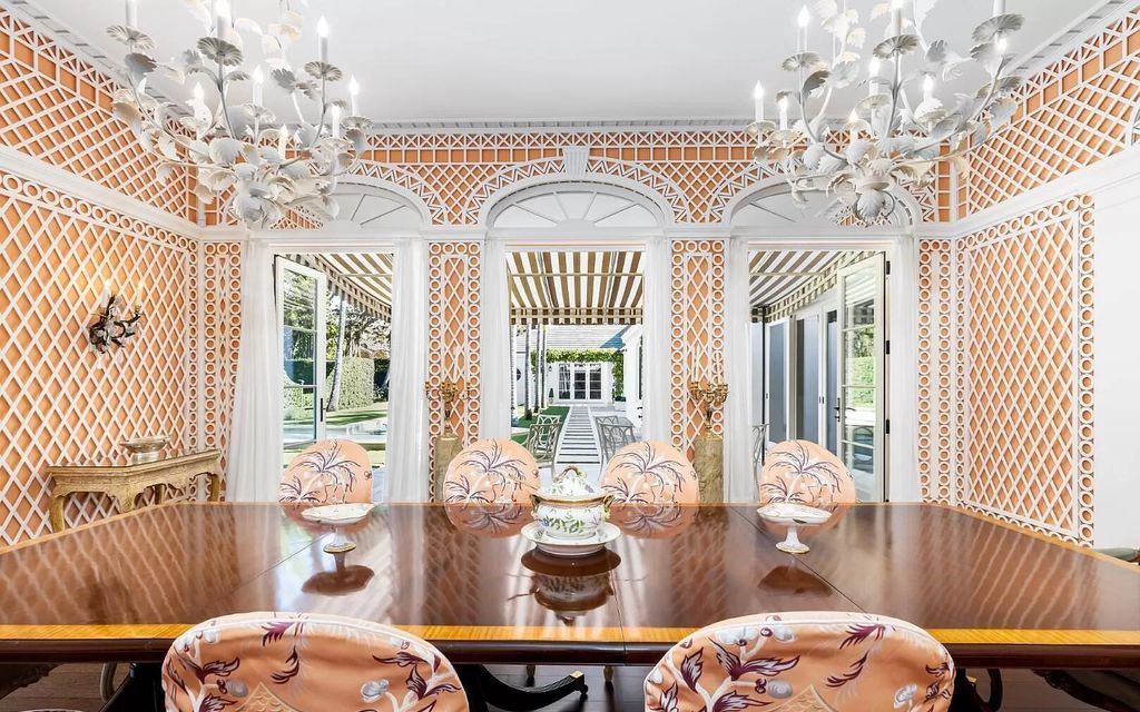 Nestled in Palm Beach's prestigious Estate Section, this 1.3+/- acre property epitomizes luxury living with a stunning clay tennis court, two guest houses, and immaculate grounds. A gated entry leads to a circular drive and ample parking, complemented by a separate service area and a 2-car garage.