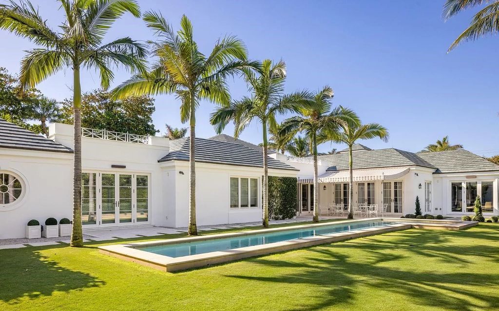 Nestled in Palm Beach's prestigious Estate Section, this 1.3+/- acre property epitomizes luxury living with a stunning clay tennis court, two guest houses, and immaculate grounds. A gated entry leads to a circular drive and ample parking, complemented by a separate service area and a 2-car garage.