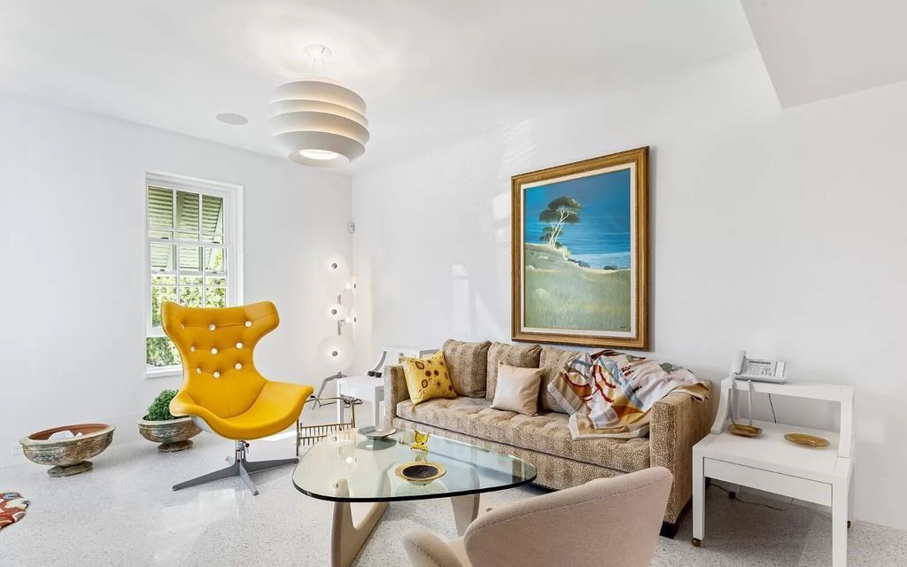 Nestled in Palm Beach's prestigious Estate Section, this 1.3+/- acre property epitomizes luxury living with a stunning clay tennis court, two guest houses, and immaculate grounds. A gated entry leads to a circular drive and ample parking, complemented by a separate service area and a 2-car garage.