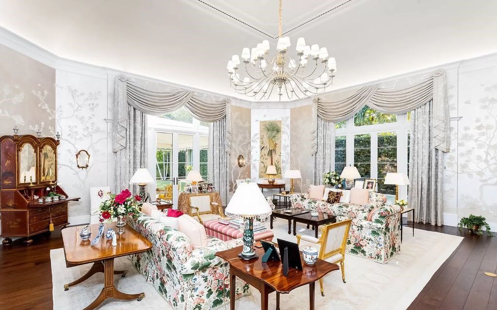 Nestled in Palm Beach's prestigious Estate Section, this 1.3+/- acre property epitomizes luxury living with a stunning clay tennis court, two guest houses, and immaculate grounds. A gated entry leads to a circular drive and ample parking, complemented by a separate service area and a 2-car garage.