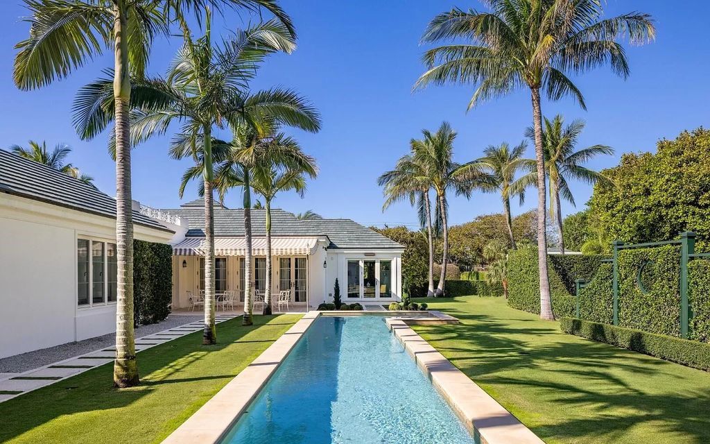 Nestled in Palm Beach's prestigious Estate Section, this 1.3+/- acre property epitomizes luxury living with a stunning clay tennis court, two guest houses, and immaculate grounds. A gated entry leads to a circular drive and ample parking, complemented by a separate service area and a 2-car garage.