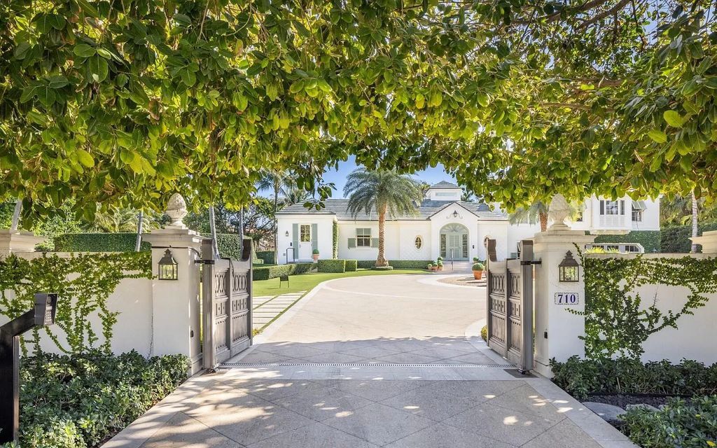Nestled in Palm Beach's prestigious Estate Section, this 1.3+/- acre property epitomizes luxury living with a stunning clay tennis court, two guest houses, and immaculate grounds. A gated entry leads to a circular drive and ample parking, complemented by a separate service area and a 2-car garage.