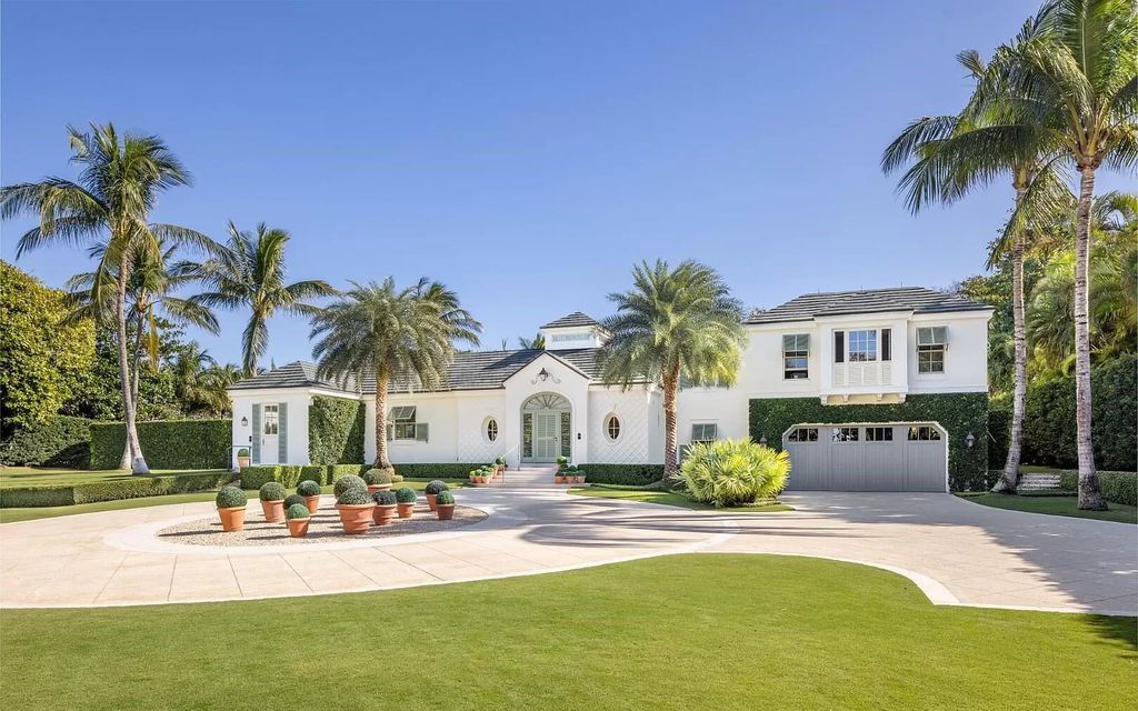 Nestled in Palm Beach's prestigious Estate Section, this 1.3+/- acre property epitomizes luxury living with a stunning clay tennis court, two guest houses, and immaculate grounds. A gated entry leads to a circular drive and ample parking, complemented by a separate service area and a 2-car garage.