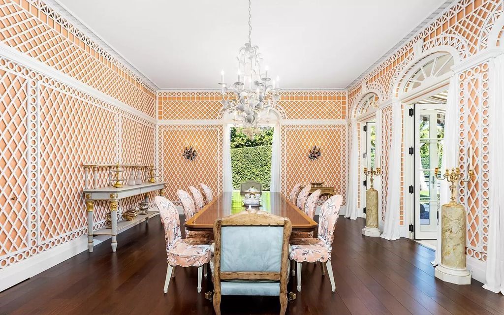 Nestled in Palm Beach's prestigious Estate Section, this 1.3+/- acre property epitomizes luxury living with a stunning clay tennis court, two guest houses, and immaculate grounds. A gated entry leads to a circular drive and ample parking, complemented by a separate service area and a 2-car garage.