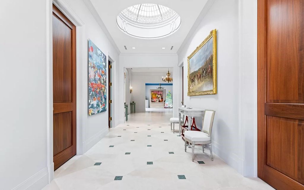 Nestled in Palm Beach's prestigious Estate Section, this 1.3+/- acre property epitomizes luxury living with a stunning clay tennis court, two guest houses, and immaculate grounds. A gated entry leads to a circular drive and ample parking, complemented by a separate service area and a 2-car garage.