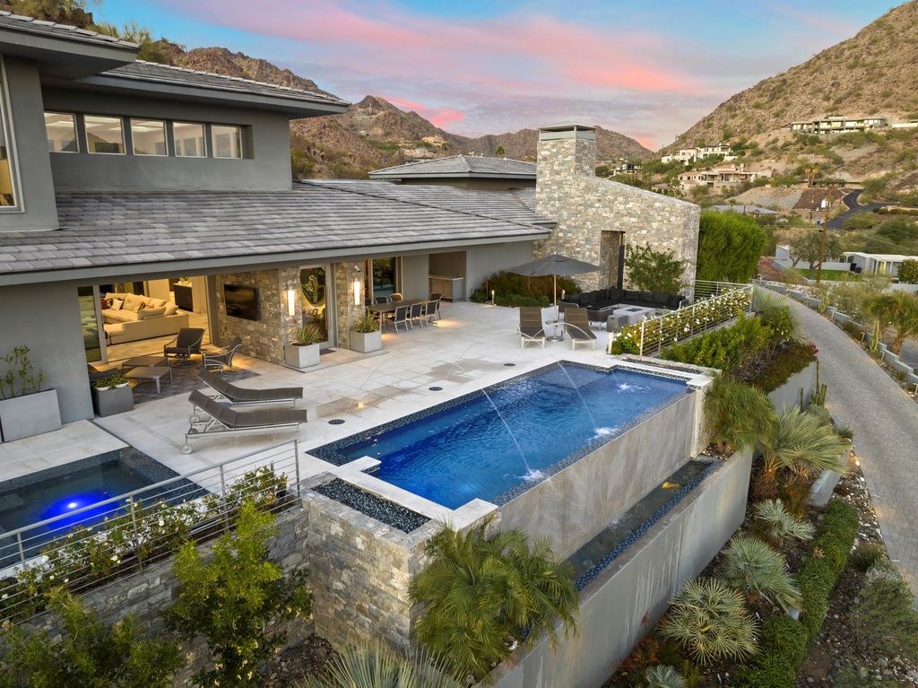 6850 North 39th Place Home in Paradise Valley, Arizona. Indulge in the epitome of luxury living with this exquisite hillside estate offering breathtaking city lights and Camelback Mountain views. Situated on just under 2.2 acres inside the guard-gated Paradise Reserve community, this newly crafted custom home seamlessly integrates indoor and outdoor spaces. 