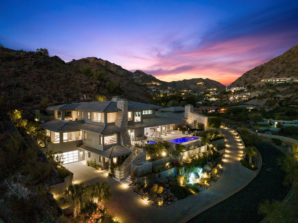6850 North 39th Place Home in Paradise Valley, Arizona. Indulge in the epitome of luxury living with this exquisite hillside estate offering breathtaking city lights and Camelback Mountain views. Situated on just under 2.2 acres inside the guard-gated Paradise Reserve community, this newly crafted custom home seamlessly integrates indoor and outdoor spaces. 