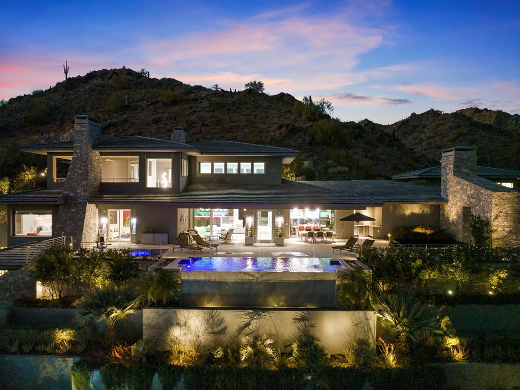 6850 North 39th Place Home in Paradise Valley, Arizona. Indulge in the epitome of luxury living with this exquisite hillside estate offering breathtaking city lights and Camelback Mountain views. Situated on just under 2.2 acres inside the guard-gated Paradise Reserve community, this newly crafted custom home seamlessly integrates indoor and outdoor spaces. 