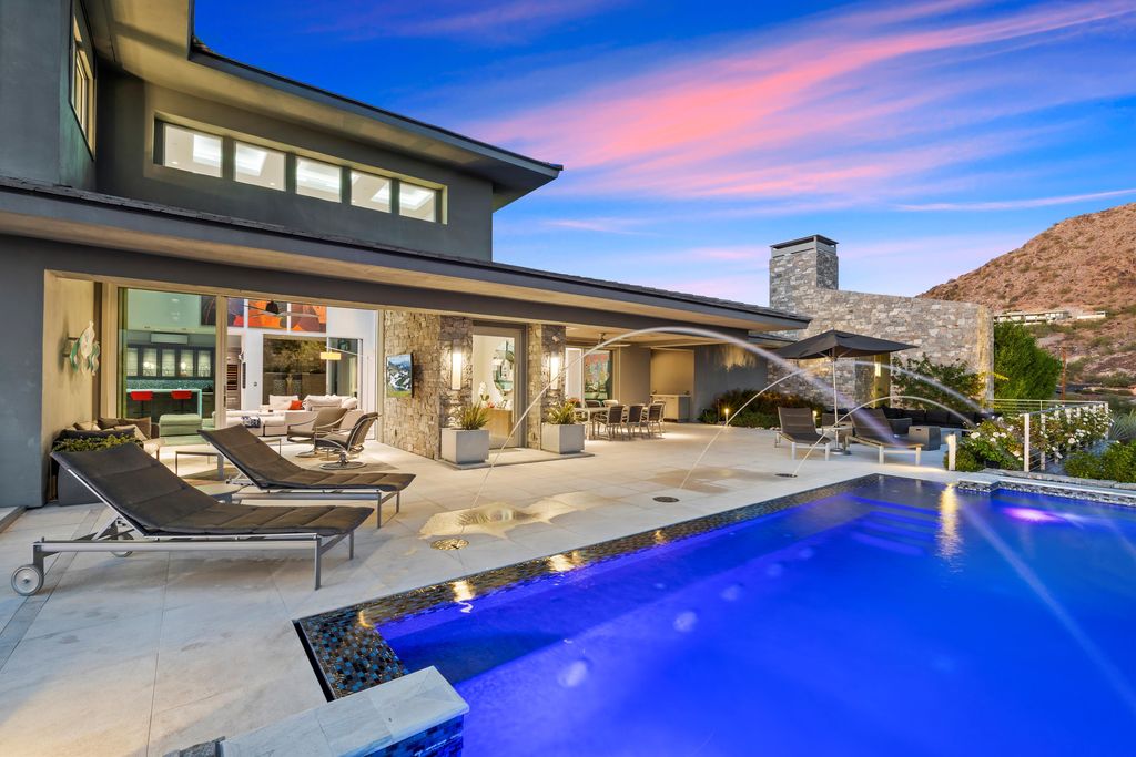 6850 North 39th Place Home in Paradise Valley, Arizona. Indulge in the epitome of luxury living with this exquisite hillside estate offering breathtaking city lights and Camelback Mountain views. Situated on just under 2.2 acres inside the guard-gated Paradise Reserve community, this newly crafted custom home seamlessly integrates indoor and outdoor spaces. 