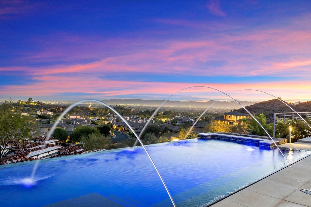 6850 North 39th Place Home in Paradise Valley, Arizona. Indulge in the epitome of luxury living with this exquisite hillside estate offering breathtaking city lights and Camelback Mountain views. Situated on just under 2.2 acres inside the guard-gated Paradise Reserve community, this newly crafted custom home seamlessly integrates indoor and outdoor spaces. 