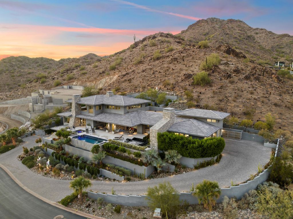 6850 North 39th Place Home in Paradise Valley, Arizona. Indulge in the epitome of luxury living with this exquisite hillside estate offering breathtaking city lights and Camelback Mountain views. Situated on just under 2.2 acres inside the guard-gated Paradise Reserve community, this newly crafted custom home seamlessly integrates indoor and outdoor spaces. 