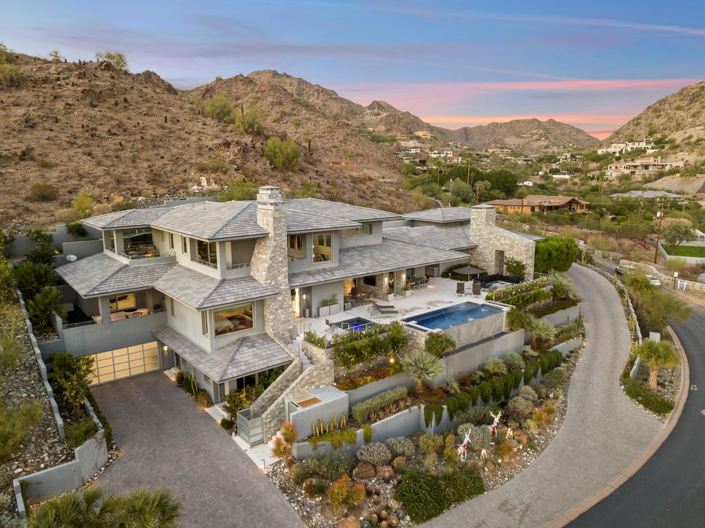 6850 North 39th Place Home in Paradise Valley, Arizona. Indulge in the epitome of luxury living with this exquisite hillside estate offering breathtaking city lights and Camelback Mountain views. Situated on just under 2.2 acres inside the guard-gated Paradise Reserve community, this newly crafted custom home seamlessly integrates indoor and outdoor spaces. 
