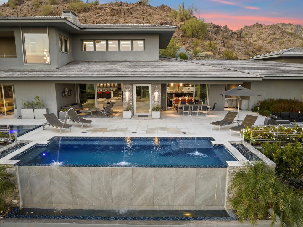 6850 North 39th Place Home in Paradise Valley, Arizona. Indulge in the epitome of luxury living with this exquisite hillside estate offering breathtaking city lights and Camelback Mountain views. Situated on just under 2.2 acres inside the guard-gated Paradise Reserve community, this newly crafted custom home seamlessly integrates indoor and outdoor spaces. 