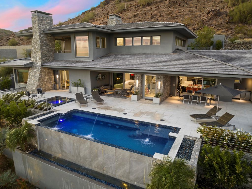 6850 North 39th Place Home in Paradise Valley, Arizona. Indulge in the epitome of luxury living with this exquisite hillside estate offering breathtaking city lights and Camelback Mountain views. Situated on just under 2.2 acres inside the guard-gated Paradise Reserve community, this newly crafted custom home seamlessly integrates indoor and outdoor spaces. 