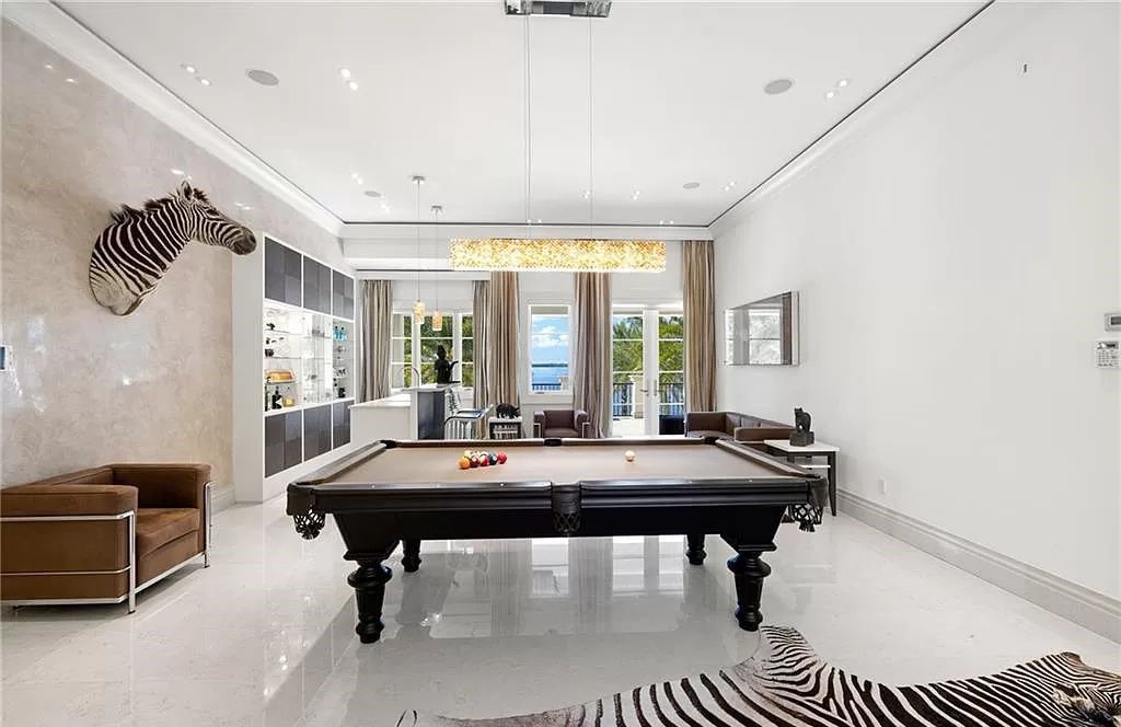 Indulge in the pinnacle of luxury at this Palladian-inspired Grand Estate in Fort Myers. Sprawling across 2 waterfront acres, this 19,184 square feet masterpiece boasts 4 bedrooms, 2 dens, a private cinema, and a 2,000-bottle wine cellar in the main residence, with an additional 3 bedrooms in the guest house.