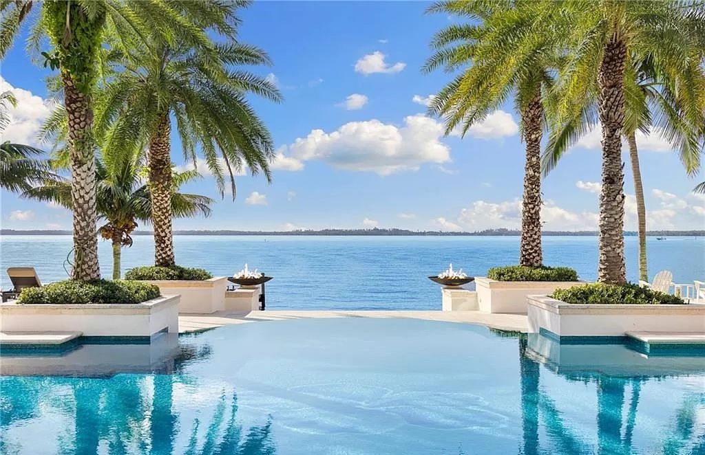 Indulge in the pinnacle of luxury at this Palladian-inspired Grand Estate in Fort Myers. Sprawling across 2 waterfront acres, this 19,184 square feet masterpiece boasts 4 bedrooms, 2 dens, a private cinema, and a 2,000-bottle wine cellar in the main residence, with an additional 3 bedrooms in the guest house.