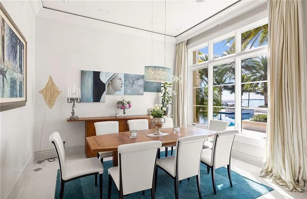 Indulge in the pinnacle of luxury at this Palladian-inspired Grand Estate in Fort Myers. Sprawling across 2 waterfront acres, this 19,184 square feet masterpiece boasts 4 bedrooms, 2 dens, a private cinema, and a 2,000-bottle wine cellar in the main residence, with an additional 3 bedrooms in the guest house.