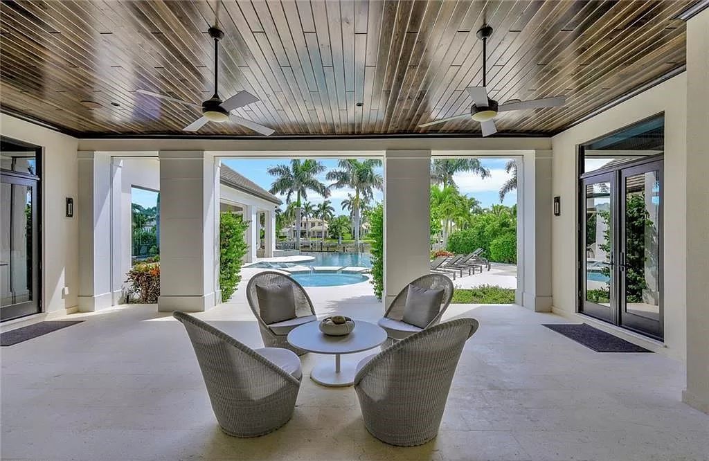 Discover an unparalleled oasis in Naples, Florida's esteemed Port Royal Community at 850 Nelsons Walk. This meticulously crafted estate seamlessly intertwines indoor and outdoor spaces, offering an entertainer's dream with an infinity-edge pool, outdoor kitchen, wine cellar, and more.