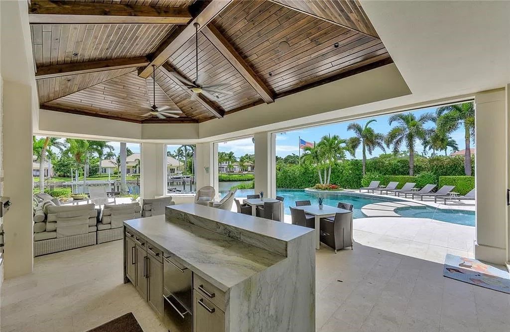 Discover an unparalleled oasis in Naples, Florida's esteemed Port Royal Community at 850 Nelsons Walk. This meticulously crafted estate seamlessly intertwines indoor and outdoor spaces, offering an entertainer's dream with an infinity-edge pool, outdoor kitchen, wine cellar, and more.