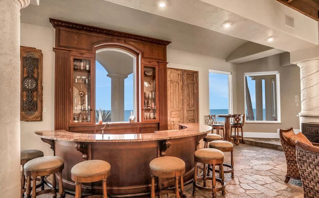 Step into the epitome of coastal luxury at 1263 Ponte Vedra Blvd, an awe-inspiring custom estate in Ponte Vedra Beach. Perched on a high bluff with 200' of ocean-frontage, this 12,751-square-foot sanctuary boasts 6 ensuite bedrooms, 7 full and 3 half baths, a media room, elevator, and a wine cellar for 2200 bottles.