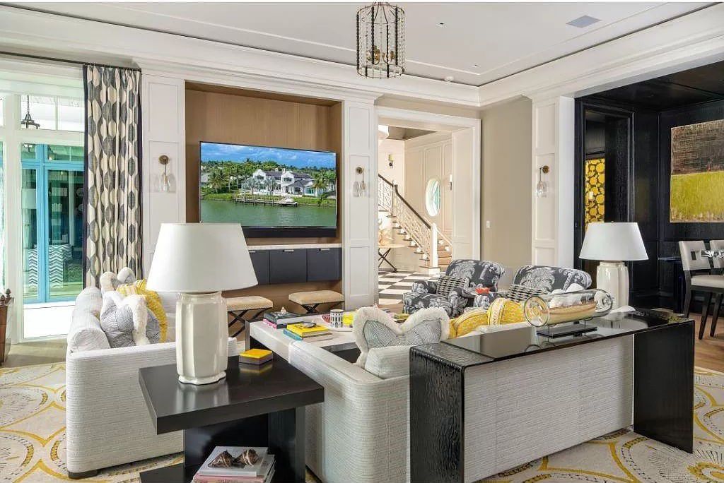 Indulge in the pinnacle of waterfront luxury at 3401 Rum Row, Naples, Florida. This exquisite property, with approximately 130 feet of shoreline, offers unparalleled vistas of Galleon Cove. Crafted by London Bay Construction, Inc. and designed by Stofft Cooney Architects, LLC, it harmonizes opulent interiors by Anthony Catalfano Interiors with lavish outdoor entertainment spaces.