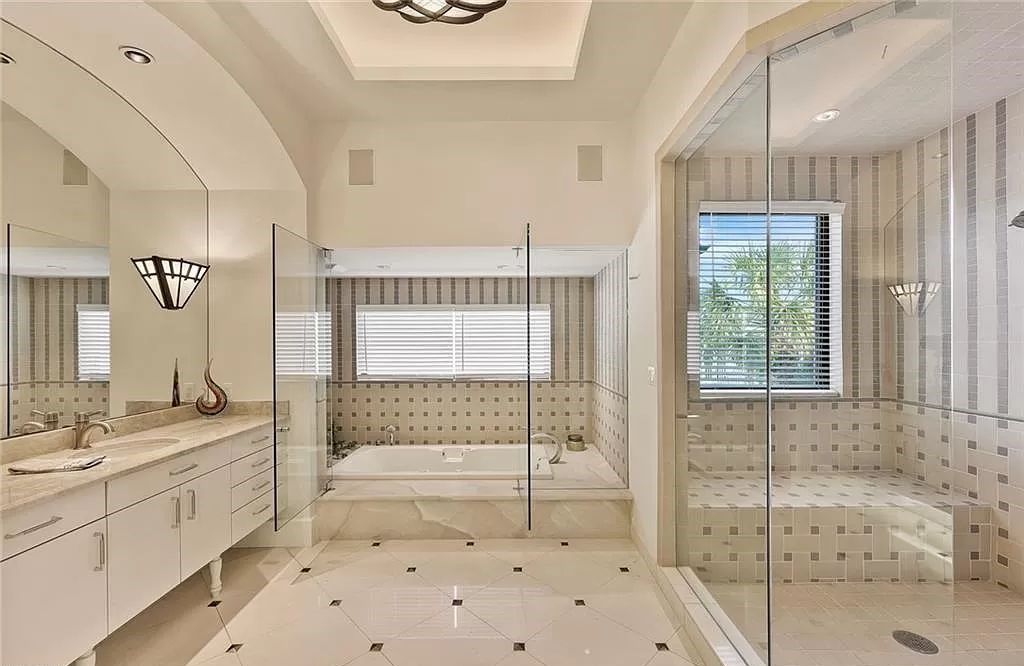 Embrace the pinnacle of coastal luxury at 1450 Gulfstar Dr S, Naples, Florida. Nestled within the exclusive Southpointe Island enclave, this architectural marvel boasts direct Gulf access and recent updates that elevate it to unparalleled sophistication.