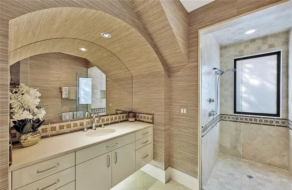 Embrace the pinnacle of coastal luxury at 1450 Gulfstar Dr S, Naples, Florida. Nestled within the exclusive Southpointe Island enclave, this architectural marvel boasts direct Gulf access and recent updates that elevate it to unparalleled sophistication.