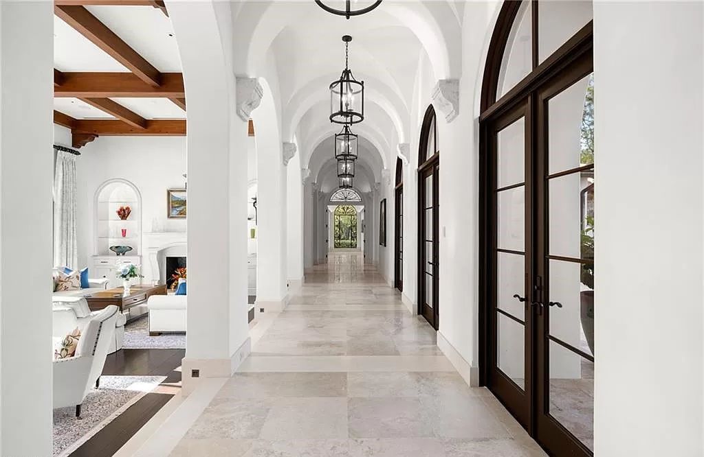Crafted by London Bay Homes, this 5-bedroom, 8-bathroom masterpiece spans 11,408 square feet on a 1.78-acre lot within the prestigious Mediterra community.