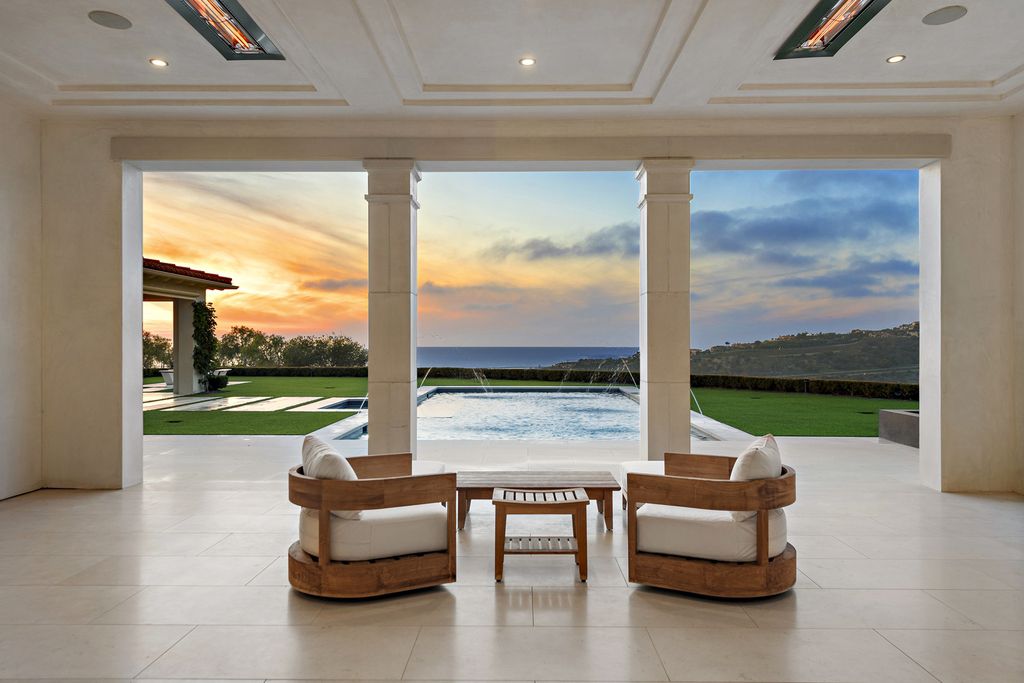 21 Spinnaker Home in Newport Coast, California. Discover luxury living at its finest in this stunning 11,700 sq. ft. estate in Crystal Cove. Completed in 2020, this meticulously designed residence offers unobstructed ocean and coastline views, dual master suites, a chef's kitchen, home theater, gym, and more. 
