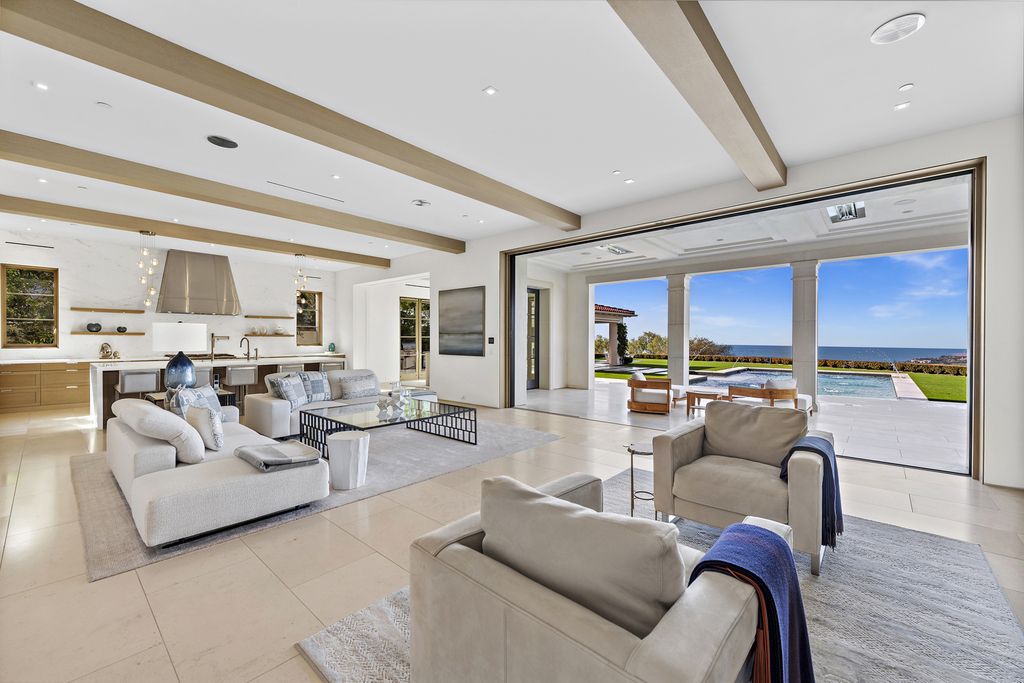 21 Spinnaker Home in Newport Coast, California. Discover luxury living at its finest in this stunning 11,700 sq. ft. estate in Crystal Cove. Completed in 2020, this meticulously designed residence offers unobstructed ocean and coastline views, dual master suites, a chef's kitchen, home theater, gym, and more. 