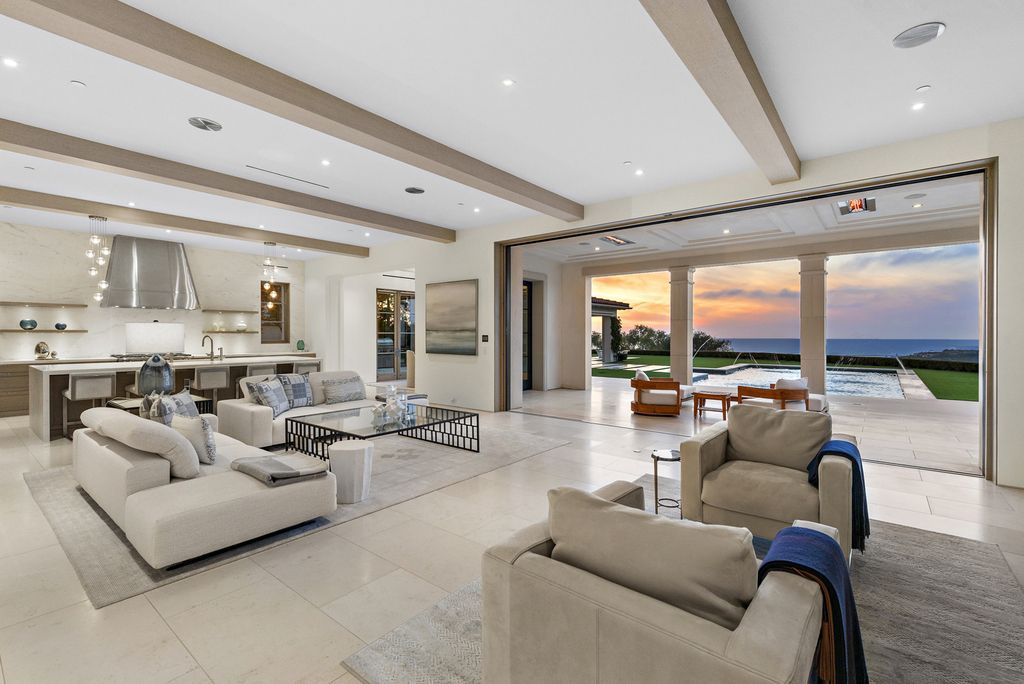 21 Spinnaker Home in Newport Coast, California. Discover luxury living at its finest in this stunning 11,700 sq. ft. estate in Crystal Cove. Completed in 2020, this meticulously designed residence offers unobstructed ocean and coastline views, dual master suites, a chef's kitchen, home theater, gym, and more. 