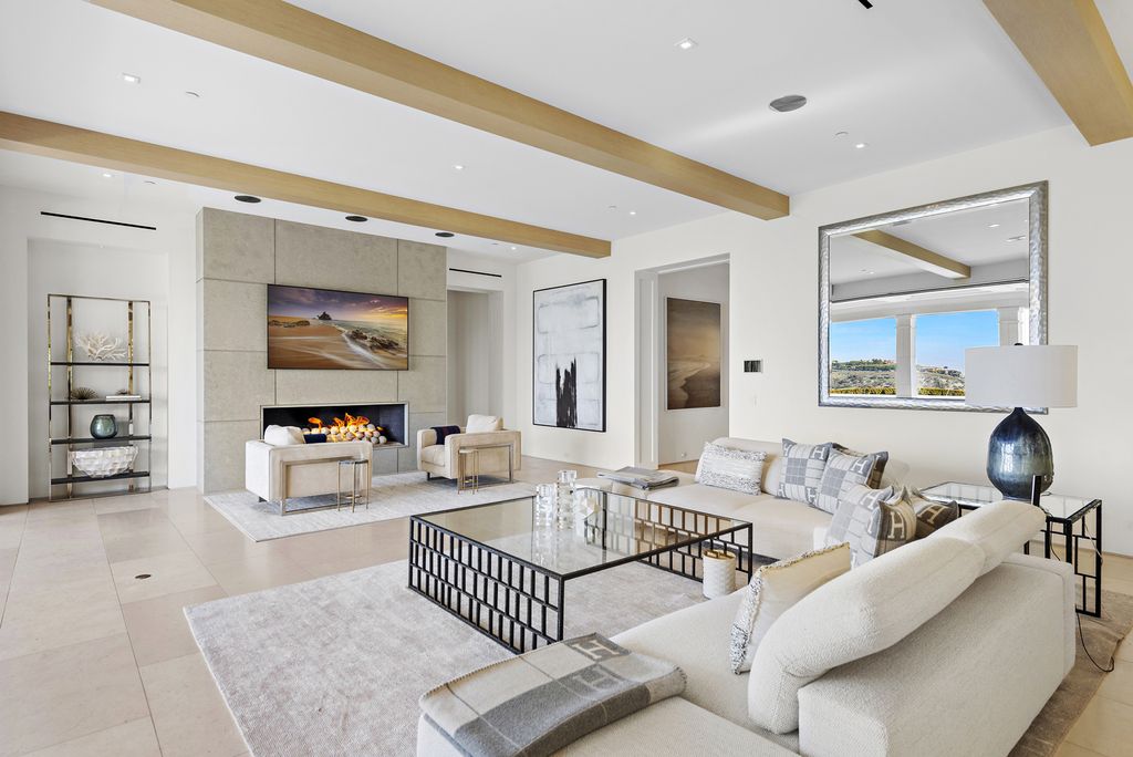 21 Spinnaker Home in Newport Coast, California. Discover luxury living at its finest in this stunning 11,700 sq. ft. estate in Crystal Cove. Completed in 2020, this meticulously designed residence offers unobstructed ocean and coastline views, dual master suites, a chef's kitchen, home theater, gym, and more. 