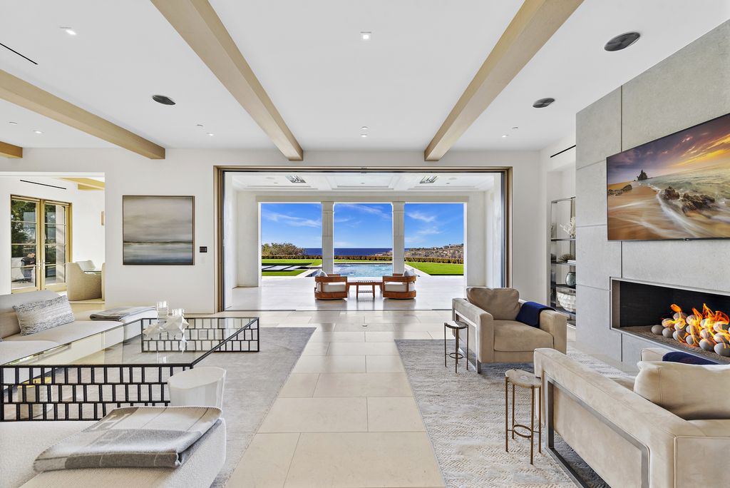 21 Spinnaker Home in Newport Coast, California. Discover luxury living at its finest in this stunning 11,700 sq. ft. estate in Crystal Cove. Completed in 2020, this meticulously designed residence offers unobstructed ocean and coastline views, dual master suites, a chef's kitchen, home theater, gym, and more. 