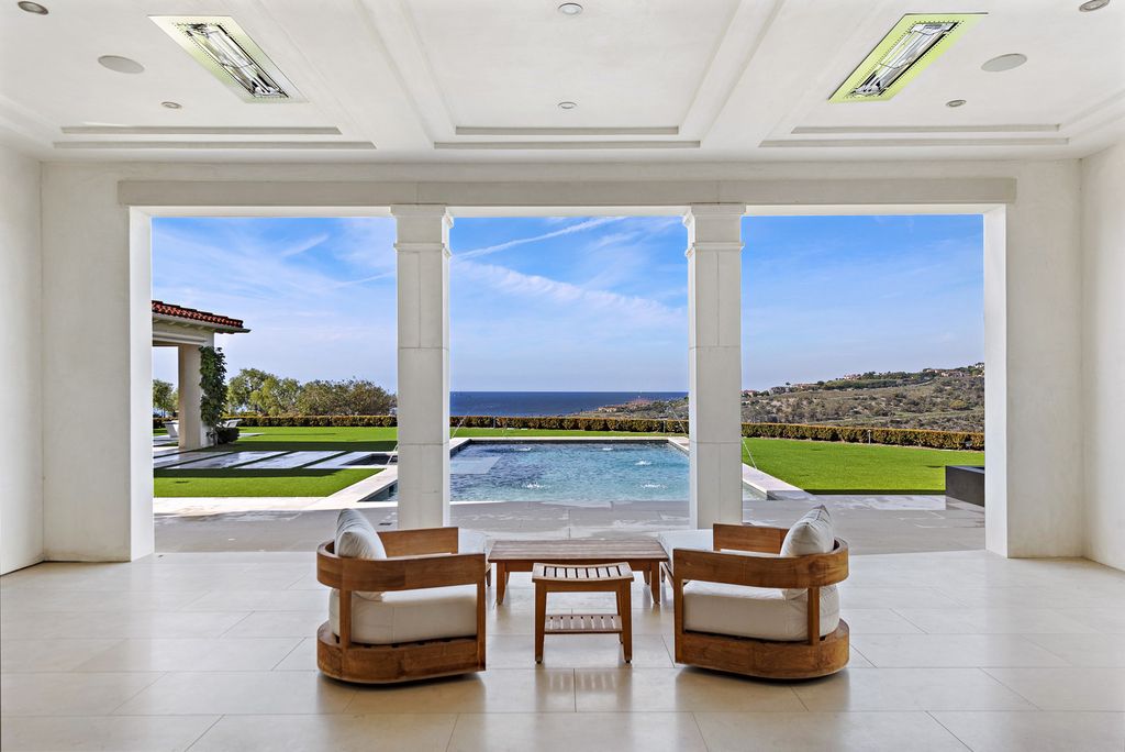 21 Spinnaker Home in Newport Coast, California. Discover luxury living at its finest in this stunning 11,700 sq. ft. estate in Crystal Cove. Completed in 2020, this meticulously designed residence offers unobstructed ocean and coastline views, dual master suites, a chef's kitchen, home theater, gym, and more. 