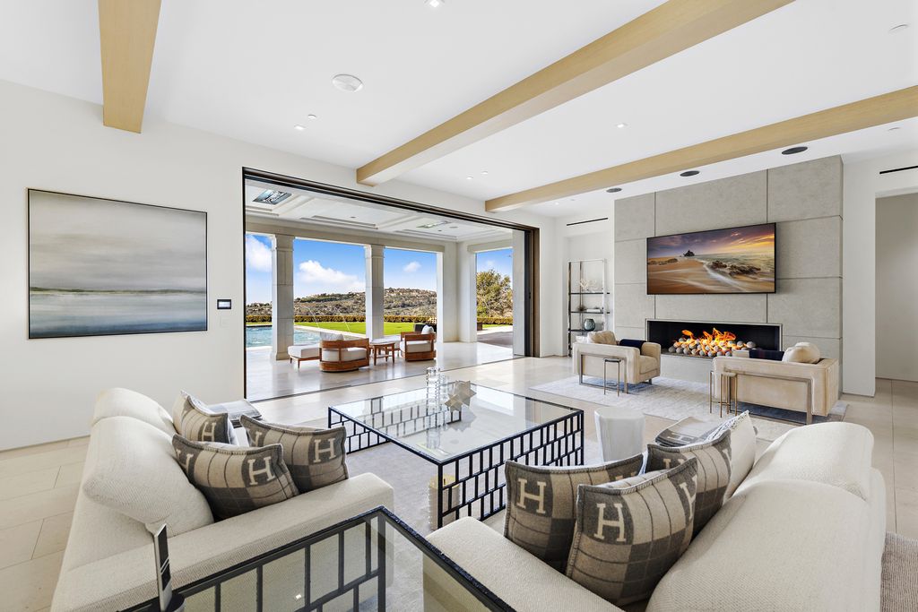21 Spinnaker Home in Newport Coast, California. Discover luxury living at its finest in this stunning 11,700 sq. ft. estate in Crystal Cove. Completed in 2020, this meticulously designed residence offers unobstructed ocean and coastline views, dual master suites, a chef's kitchen, home theater, gym, and more. 