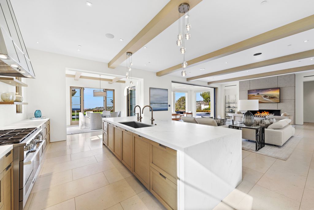 21 Spinnaker Home in Newport Coast, California. Discover luxury living at its finest in this stunning 11,700 sq. ft. estate in Crystal Cove. Completed in 2020, this meticulously designed residence offers unobstructed ocean and coastline views, dual master suites, a chef's kitchen, home theater, gym, and more. 