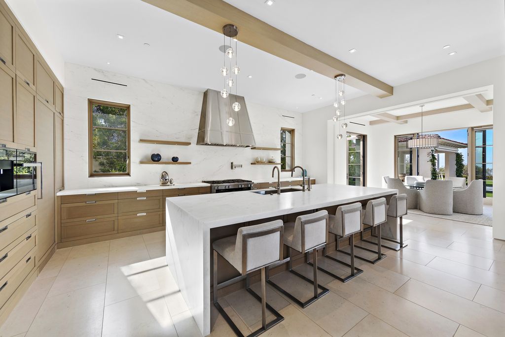 21 Spinnaker Home in Newport Coast, California. Discover luxury living at its finest in this stunning 11,700 sq. ft. estate in Crystal Cove. Completed in 2020, this meticulously designed residence offers unobstructed ocean and coastline views, dual master suites, a chef's kitchen, home theater, gym, and more. 
