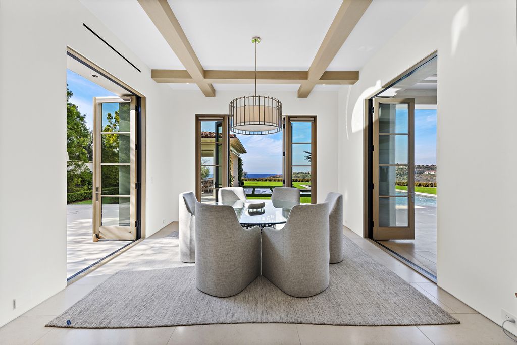 21 Spinnaker Home in Newport Coast, California. Discover luxury living at its finest in this stunning 11,700 sq. ft. estate in Crystal Cove. Completed in 2020, this meticulously designed residence offers unobstructed ocean and coastline views, dual master suites, a chef's kitchen, home theater, gym, and more. 