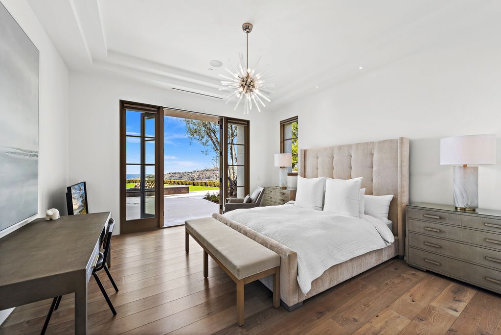 21 Spinnaker Home in Newport Coast, California. Discover luxury living at its finest in this stunning 11,700 sq. ft. estate in Crystal Cove. Completed in 2020, this meticulously designed residence offers unobstructed ocean and coastline views, dual master suites, a chef's kitchen, home theater, gym, and more. 