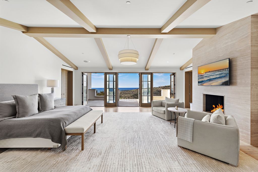21 Spinnaker Home in Newport Coast, California. Discover luxury living at its finest in this stunning 11,700 sq. ft. estate in Crystal Cove. Completed in 2020, this meticulously designed residence offers unobstructed ocean and coastline views, dual master suites, a chef's kitchen, home theater, gym, and more. 