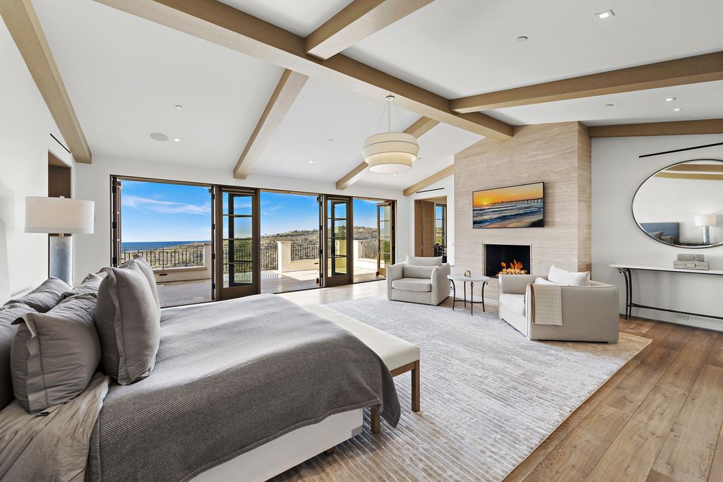 21 Spinnaker Home in Newport Coast, California. Discover luxury living at its finest in this stunning 11,700 sq. ft. estate in Crystal Cove. Completed in 2020, this meticulously designed residence offers unobstructed ocean and coastline views, dual master suites, a chef's kitchen, home theater, gym, and more. 