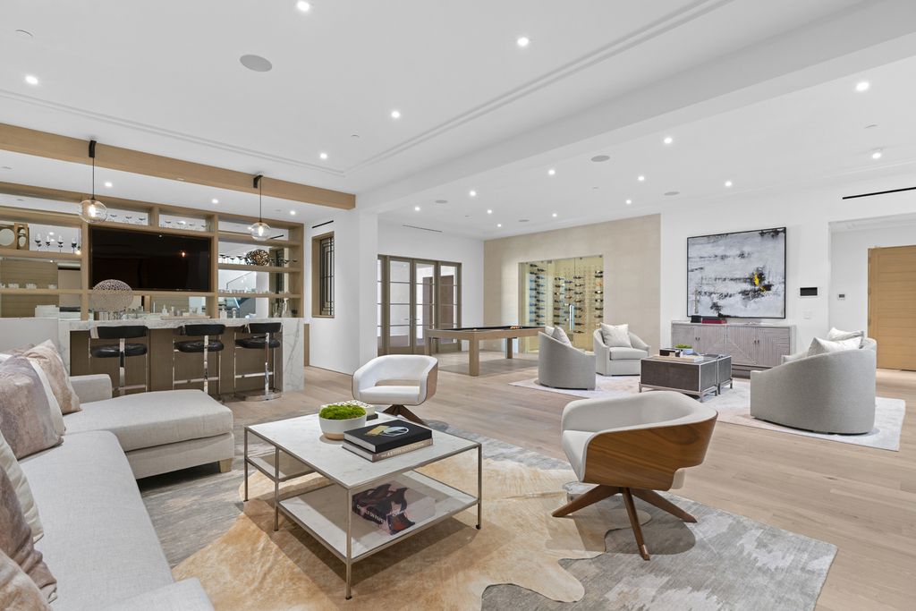 21 Spinnaker Home in Newport Coast, California. Discover luxury living at its finest in this stunning 11,700 sq. ft. estate in Crystal Cove. Completed in 2020, this meticulously designed residence offers unobstructed ocean and coastline views, dual master suites, a chef's kitchen, home theater, gym, and more. 