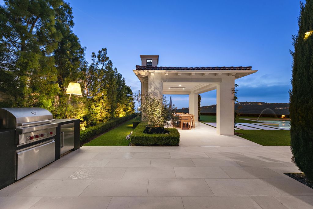 21 Spinnaker Home in Newport Coast, California. Discover luxury living at its finest in this stunning 11,700 sq. ft. estate in Crystal Cove. Completed in 2020, this meticulously designed residence offers unobstructed ocean and coastline views, dual master suites, a chef's kitchen, home theater, gym, and more. 
