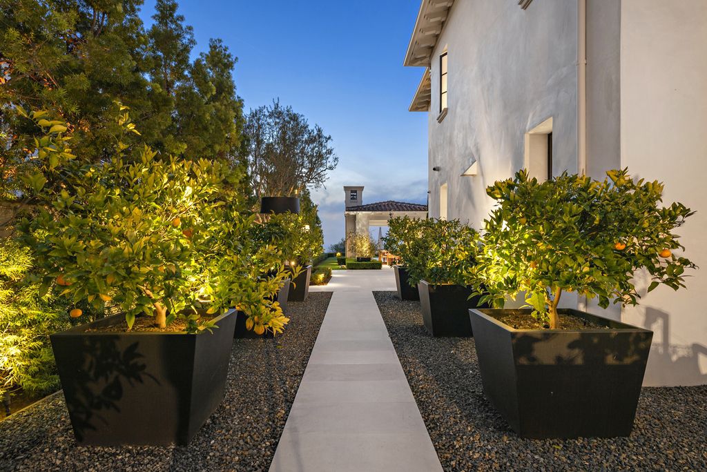 21 Spinnaker Home in Newport Coast, California. Discover luxury living at its finest in this stunning 11,700 sq. ft. estate in Crystal Cove. Completed in 2020, this meticulously designed residence offers unobstructed ocean and coastline views, dual master suites, a chef's kitchen, home theater, gym, and more. 