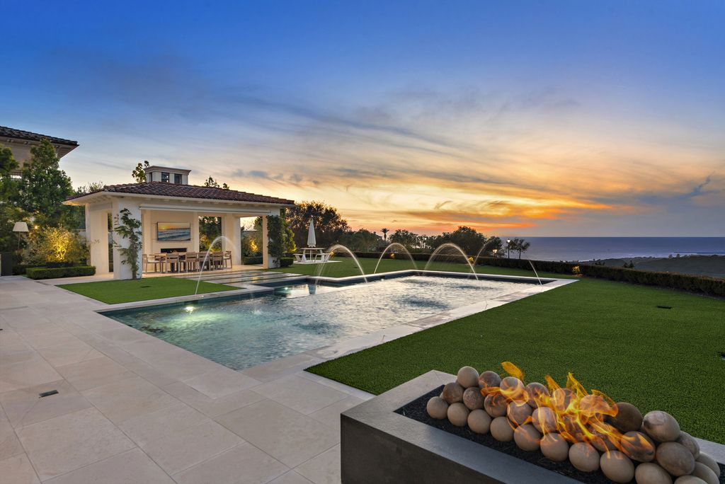 21 Spinnaker Home in Newport Coast, California. Discover luxury living at its finest in this stunning 11,700 sq. ft. estate in Crystal Cove. Completed in 2020, this meticulously designed residence offers unobstructed ocean and coastline views, dual master suites, a chef's kitchen, home theater, gym, and more. 